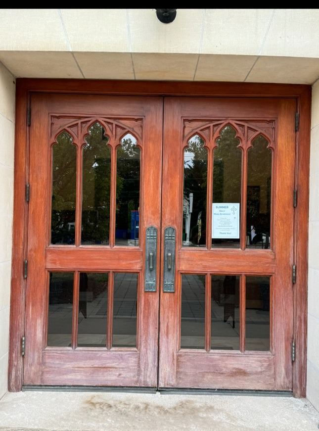 Weathered wood church door before refinishing