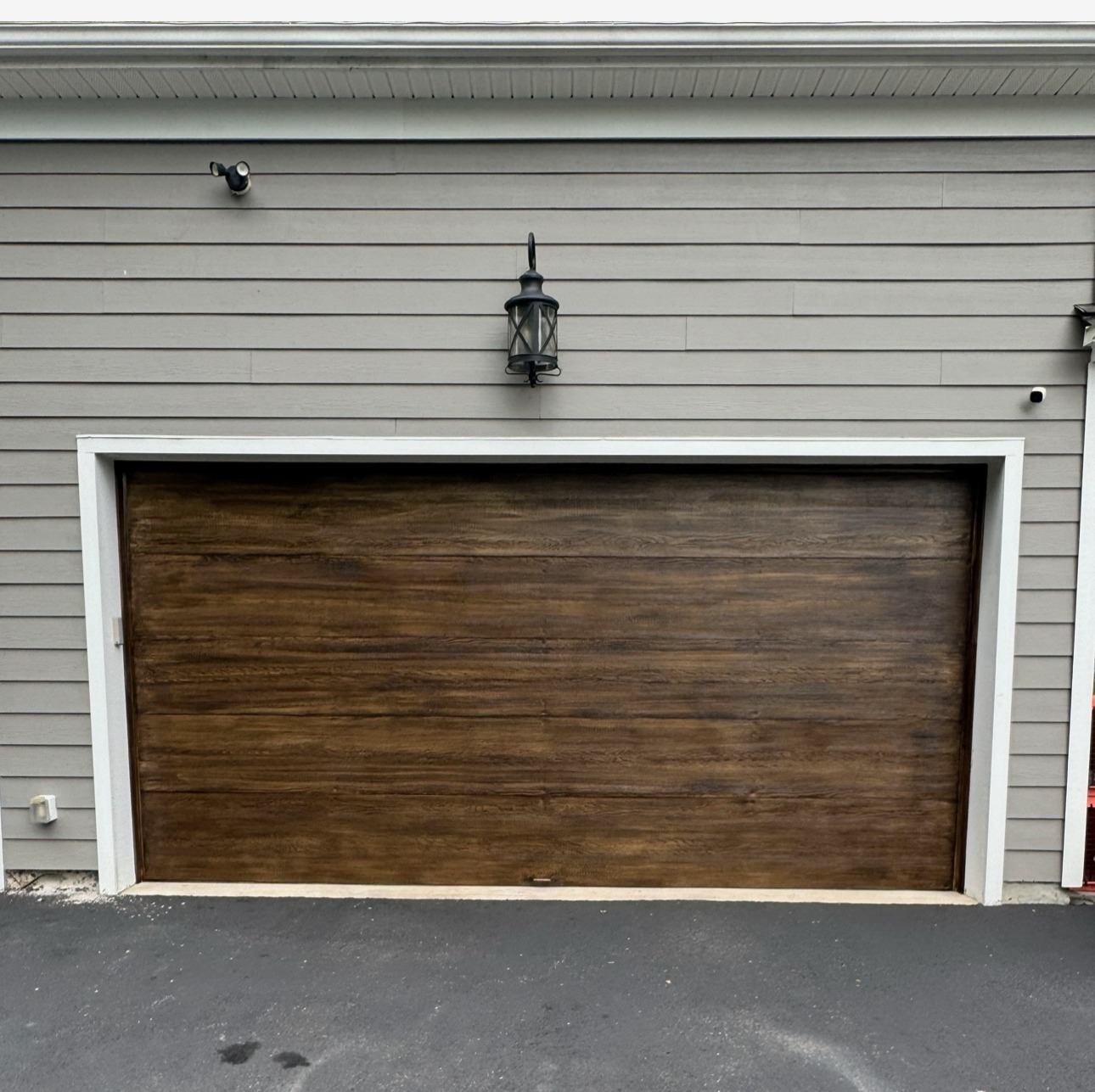 Garage door after custom wood-look faux finish